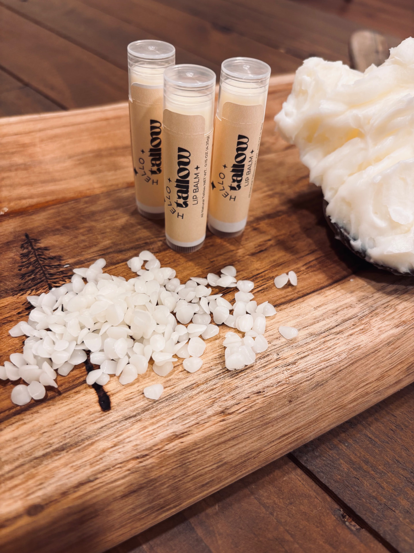 Four Hello Tallow unscented tallow lip balms beside their simple ingredients